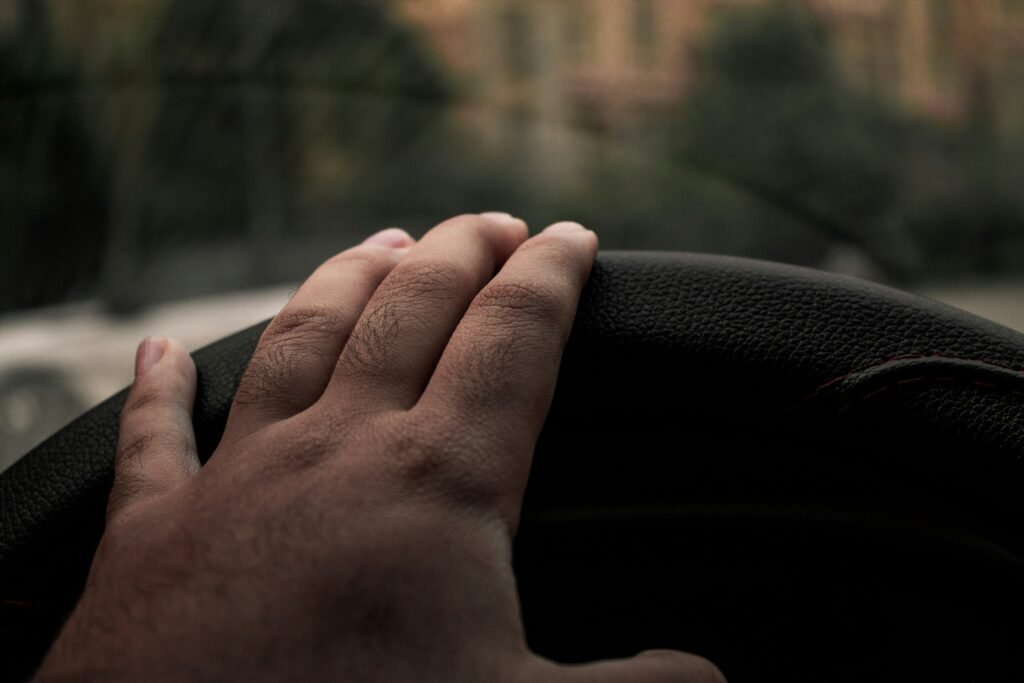 A confident driver scanning the road, debunking common defensive driving myths about being passive.